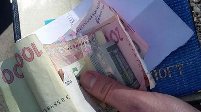 ​Київські оперативники затримали шахрайку, яка видурила у жінки гроші під час зняття порчі